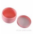 Lege cosmetische roze plastic gevormde crèmekleurige gezichtskom